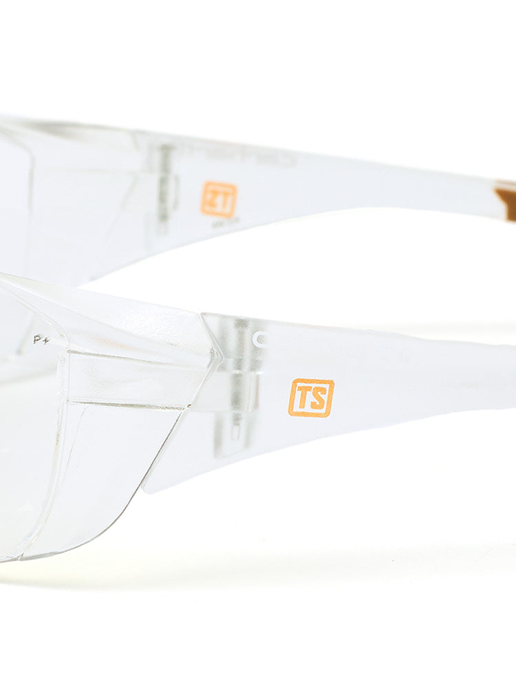Close-up side view of clear Carhartt Billings safety glasses with a small orange Train SMART logo on each side.